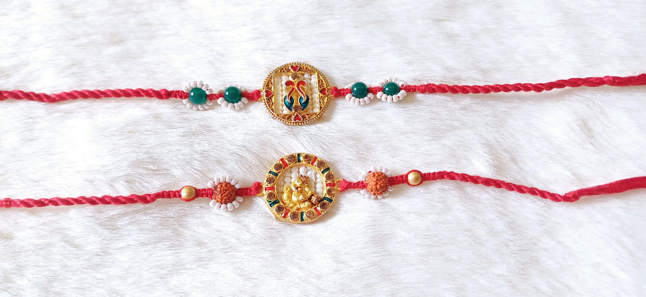 Couple Rakhi with Ganesha and Peacock design in Red and Green color
