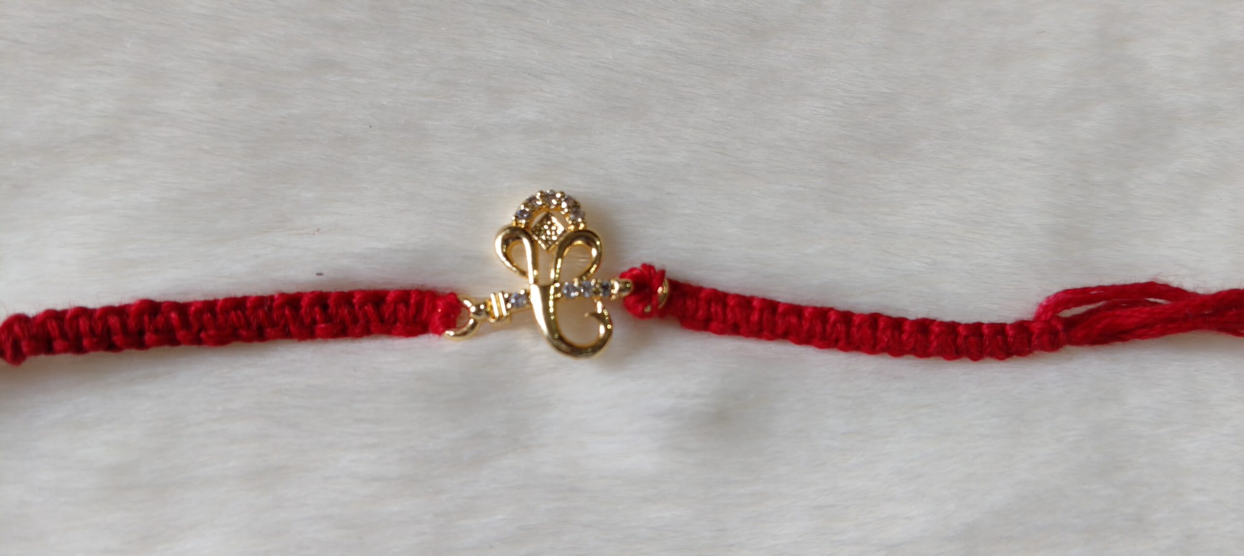 Red color with Golden Ganesh Design Rakhi