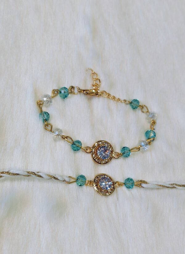 Couple Rakhi - Golden and Blue color with Maroon Circle shaped pearl - Image 2
