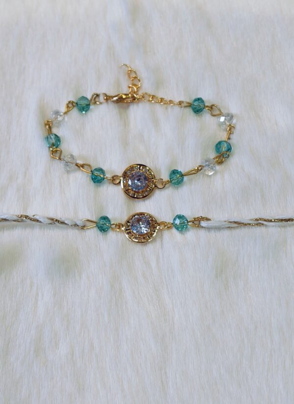 Couple Rakhi - Golden and Blue color with Maroon Circle shaped pearl - Image 3