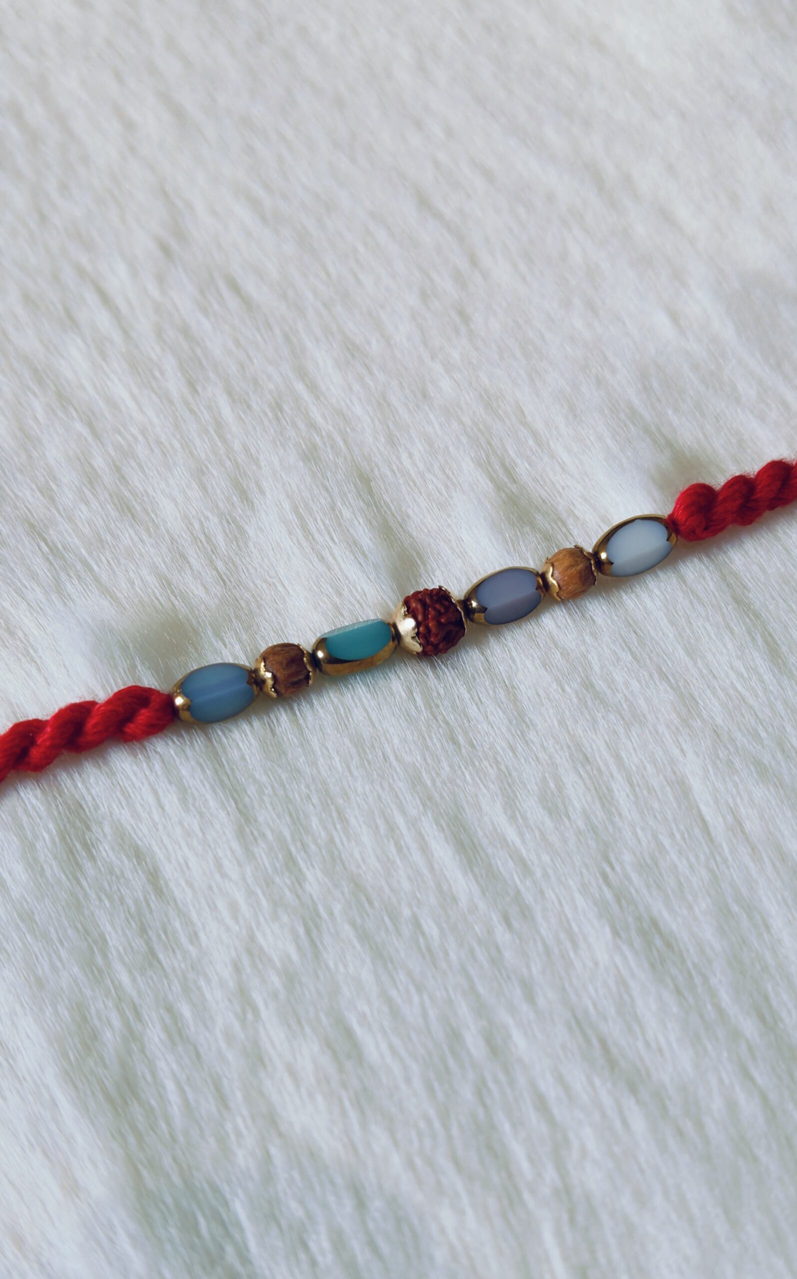 Red color with Rudraksha and Pearls in Blue and Light Blue color