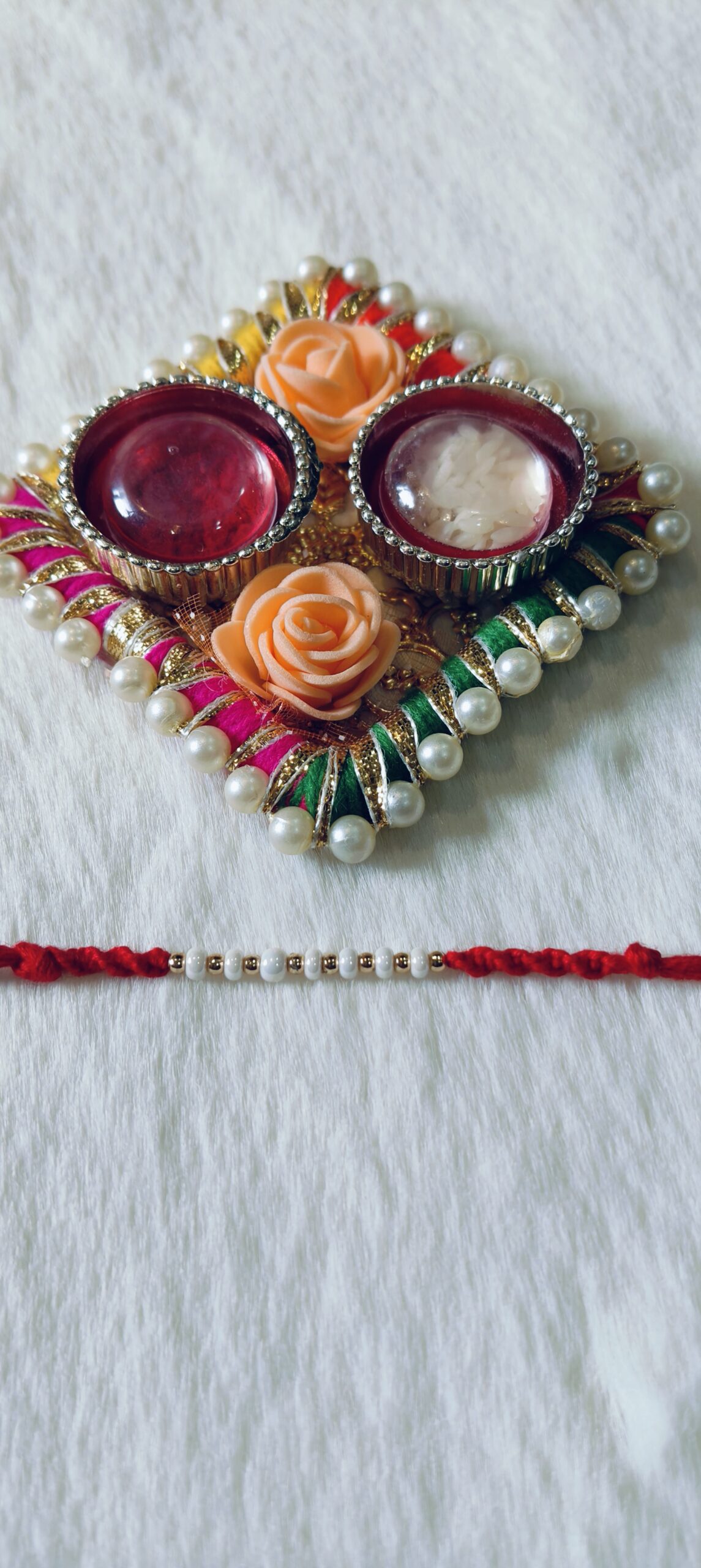 Red color with white and golden pearls
